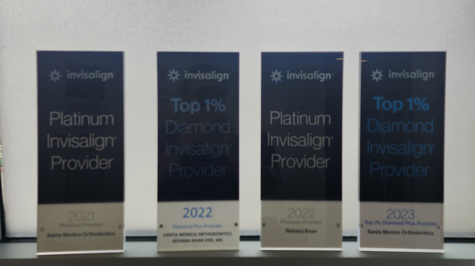 Invisalign Platinum and Top 1% Diamond Provider plaques, 2021–2023