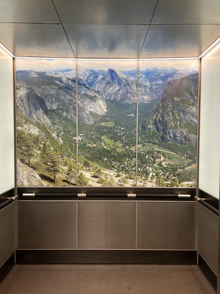 Backlit Yosemite mural lining the elevator lobby of the Downtown Los Angeles office building