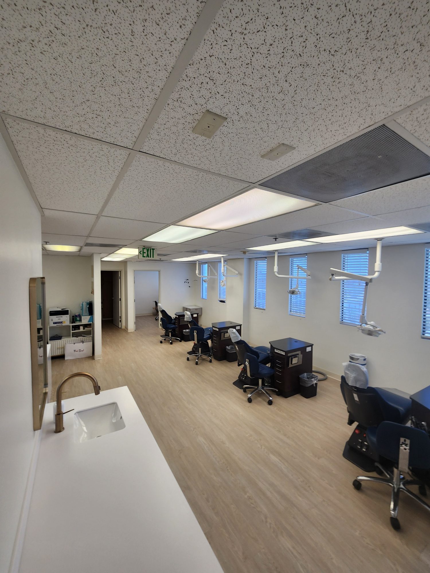 The open treatment bay at the Downtown Los Angeles office, with chairs along a wall of windows